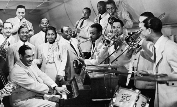 group of black people singing and playing Jazz instruments