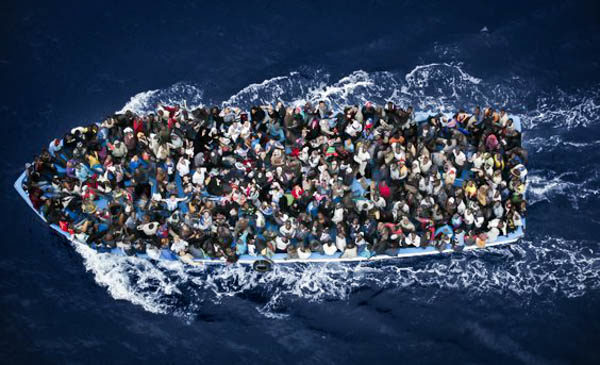 several people on a crowded boat in the ocean