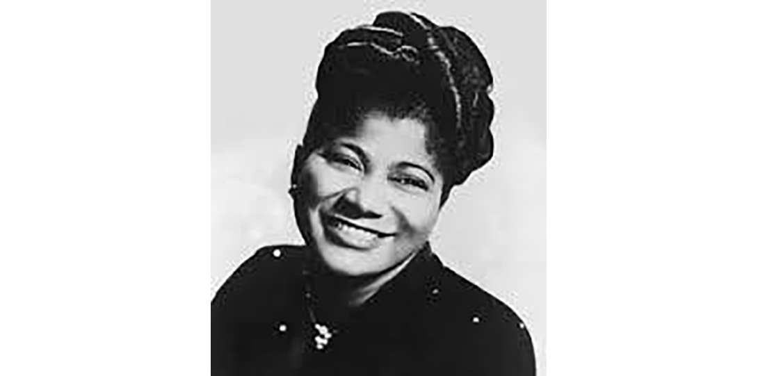 Mahalia Jackson smiling for photograph with slightly titled head