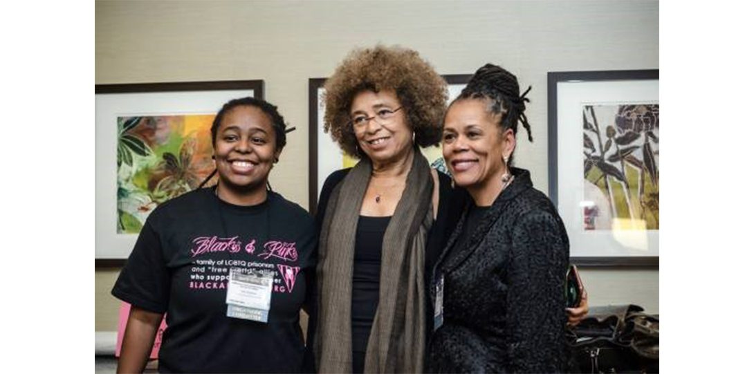 Ash posing for a photograph with Angela Davis and Beth Richie