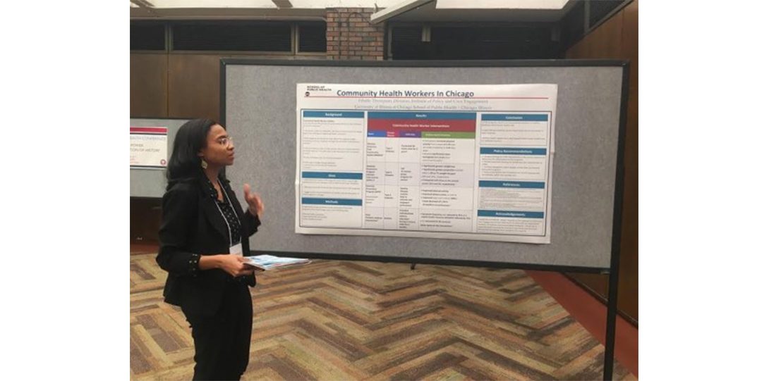 person speaking in front of research poster entitled 