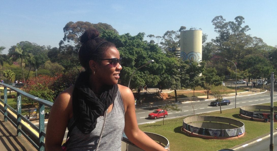 Professor Jaira Harrington atop of bridge overlooking automobile