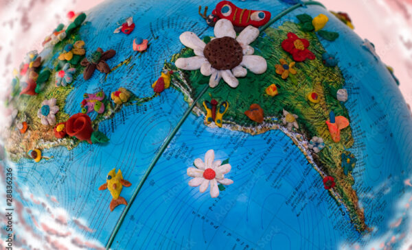close up of globe. flowers cover sections of central and south america